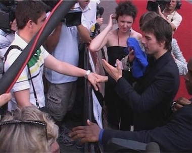 Hollywood star Tom Cruise wipes his face with a towel, Sunday June 19, 2005, in central London after being doused with water during his walkabout before the premiere of his new film War of the Worlds. Cruise was speaking to journalists when a man with a microphone squirted water in his face and all over his jacket.